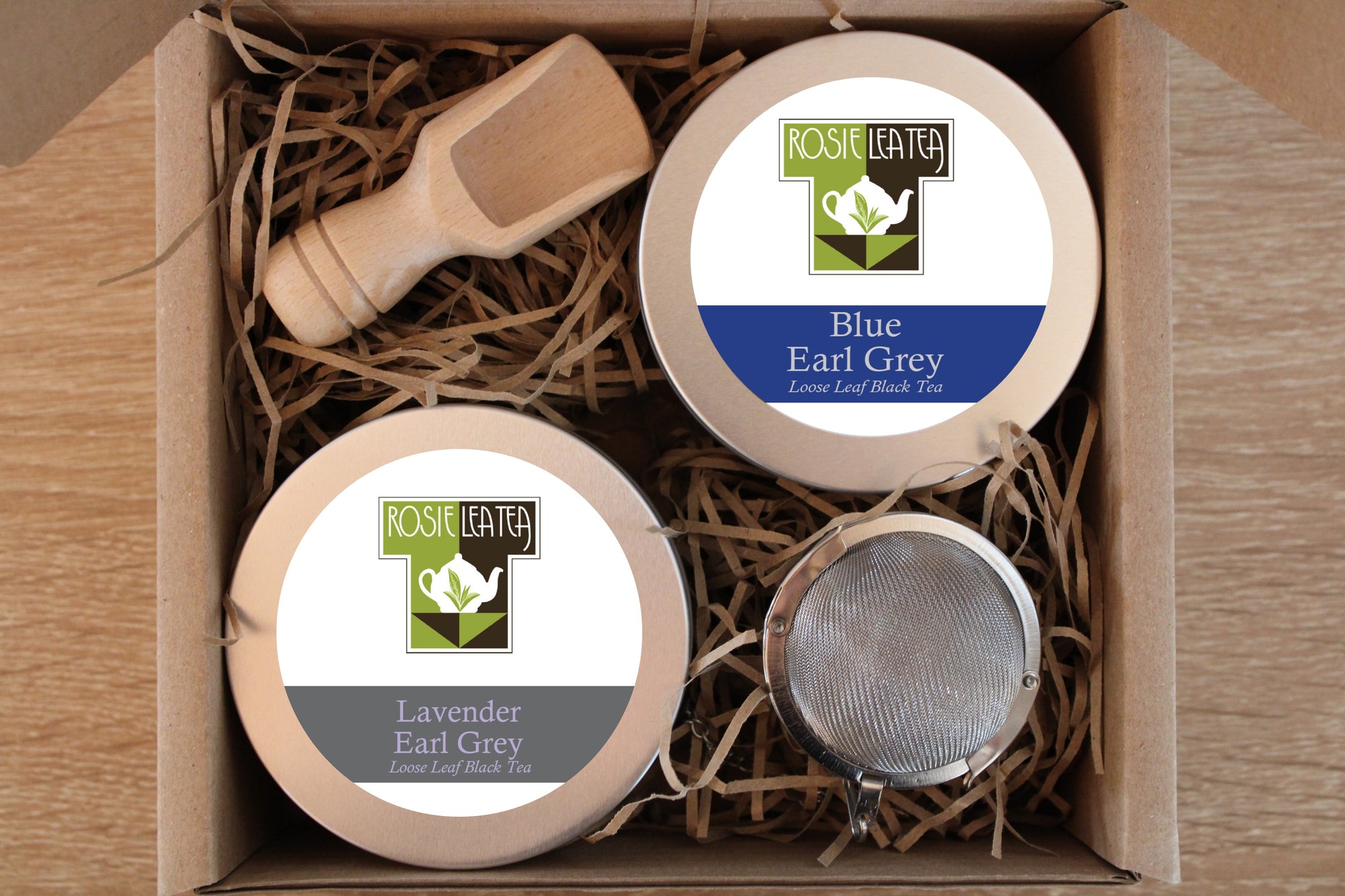 gift box with 4 tins of tea and tea infuser and wooden scoop